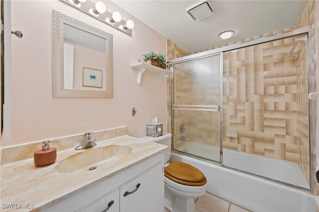 full bathroom with toilet, vanity, tile patterned flooring, and bath / shower combo with glass door