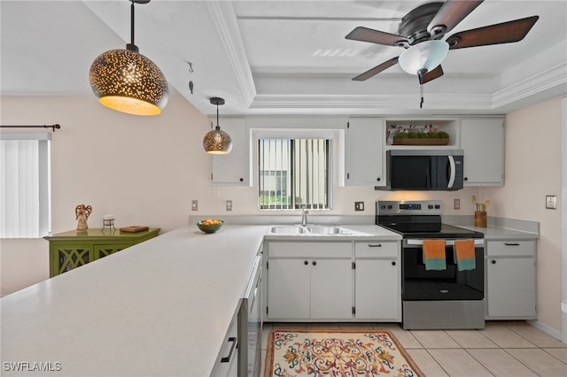 kitchen with stainless steel appliances, sink, a raised ceiling, white cabinets, and pendant lighting