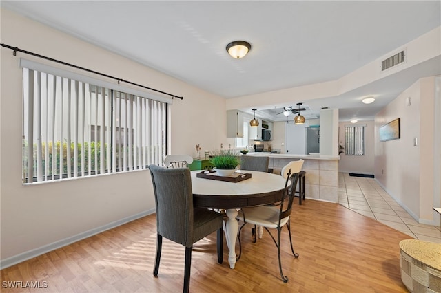 dining area with light hardwood / wood-style floors