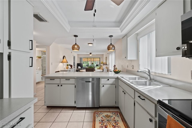 kitchen with sink, white cabinetry, a tray ceiling, pendant lighting, and stainless steel appliances