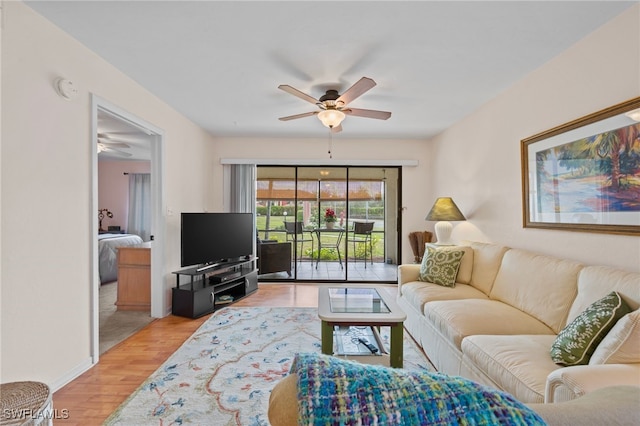 living room with ceiling fan and light hardwood / wood-style floors