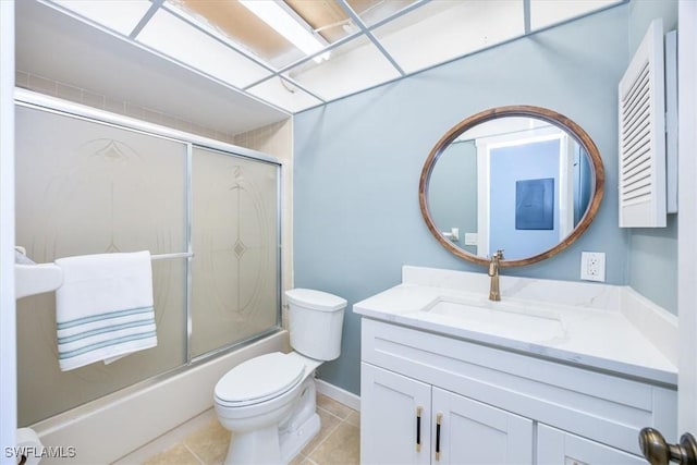 full bathroom with toilet, vanity, shower / bath combination with glass door, and tile patterned flooring