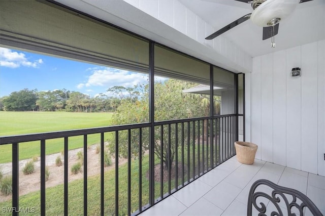 unfurnished sunroom featuring ceiling fan