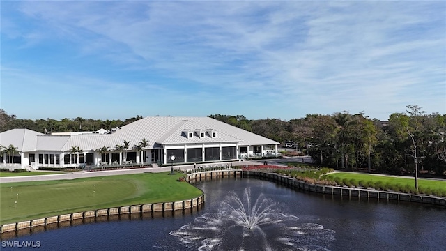 back of property featuring a water view