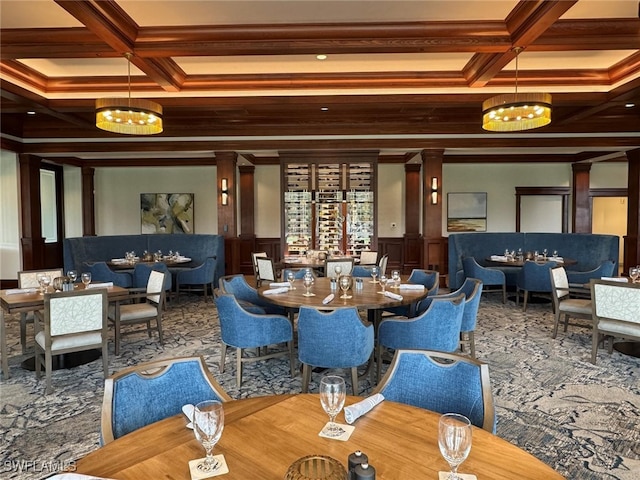 interior space featuring beamed ceiling, coffered ceiling, and ornate columns