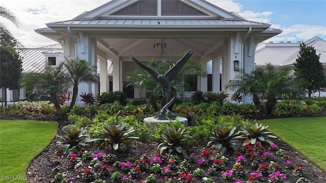 view of exterior entry with a yard