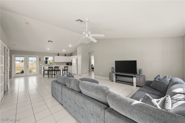 living room featuring french doors, ceiling fan, vaulted ceiling, and light tile patterned floors