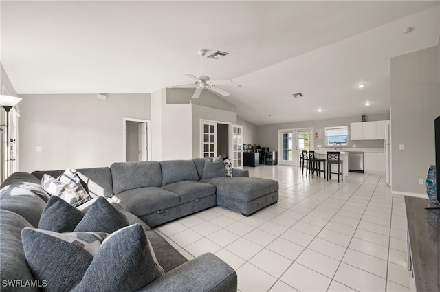 living room with light tile patterned flooring, lofted ceiling, ceiling fan, and french doors