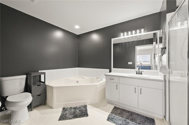 bathroom with vanity, a tub, and toilet