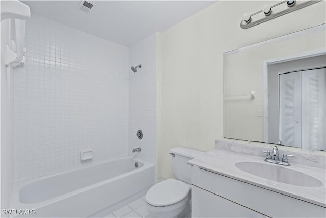 full bathroom featuring toilet, tiled shower / bath, tile patterned flooring, and vanity