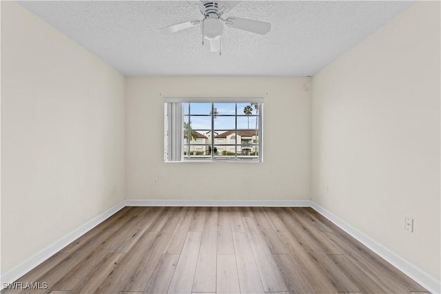 spare room featuring a textured ceiling, ceiling fan, and light hardwood / wood-style flooring