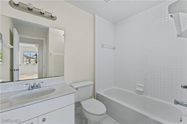 full bathroom featuring toilet, tile patterned floors, tiled shower / bath, and vanity