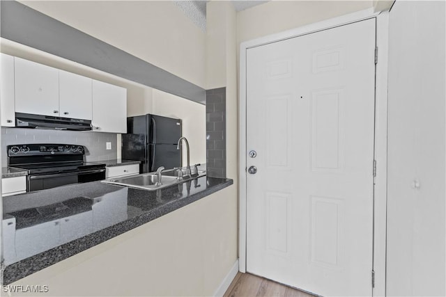 kitchen with black appliances, white cabinetry, sink, backsplash, and light wood-type flooring