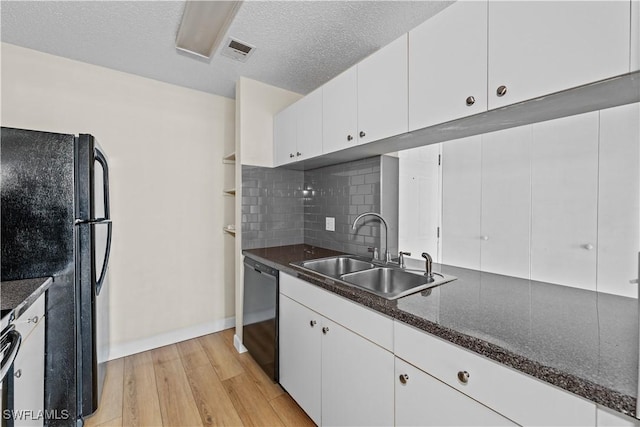 kitchen with white cabinetry, sink, backsplash, and black appliances