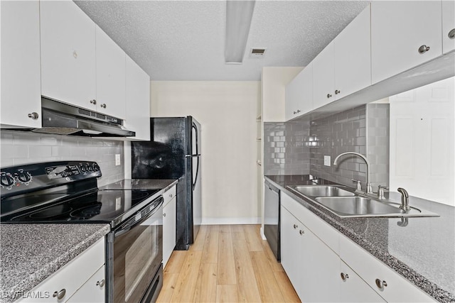 kitchen featuring dishwasher, black electric range, white cabinetry, light hardwood / wood-style flooring, and a textured ceiling