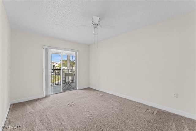 carpeted empty room featuring ceiling fan and a textured ceiling