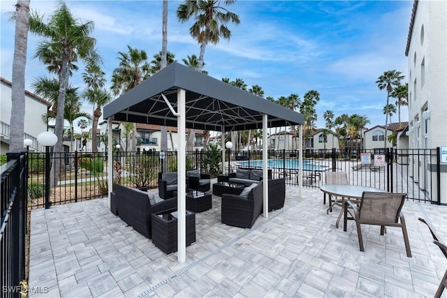 view of patio / terrace with grilling area, a community pool, and outdoor lounge area