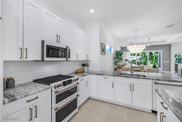 kitchen featuring white cabinets, light stone counters, sink, and white appliances