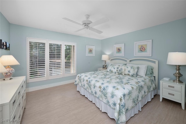 bedroom with light wood-type flooring and ceiling fan