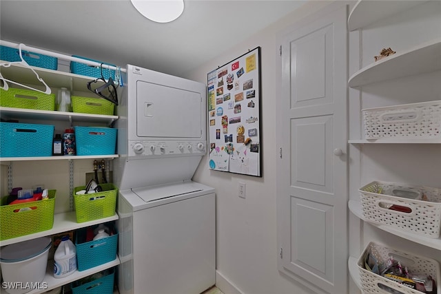 laundry room with stacked washing maching and dryer