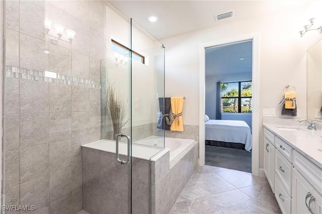 bathroom featuring vanity and separate shower and tub