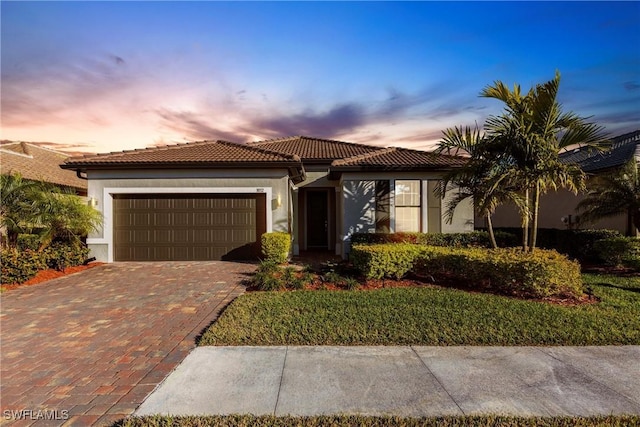 mediterranean / spanish-style house with a garage