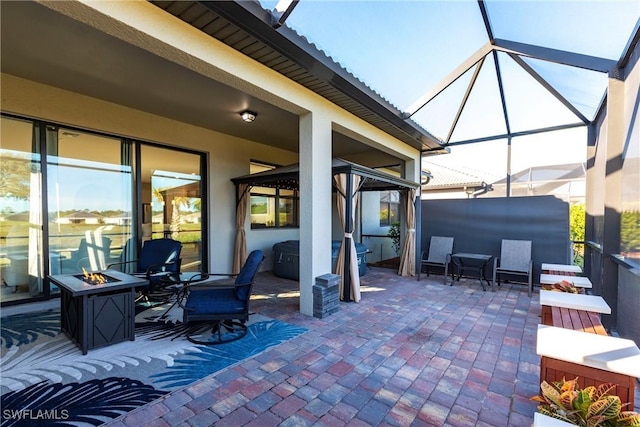 view of patio / terrace with a lanai and an outdoor fire pit