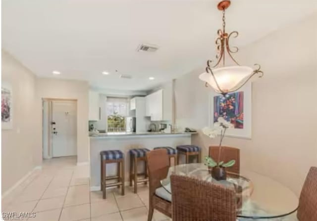 dining space featuring light tile patterned floors