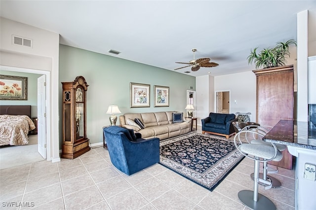 tiled living room featuring ceiling fan