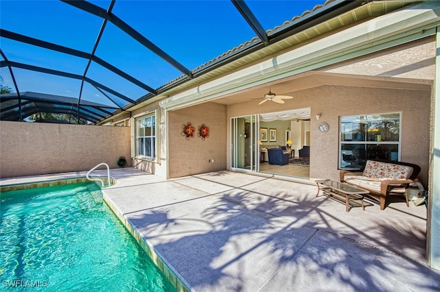 view of swimming pool featuring a lanai, ceiling fan, and a patio