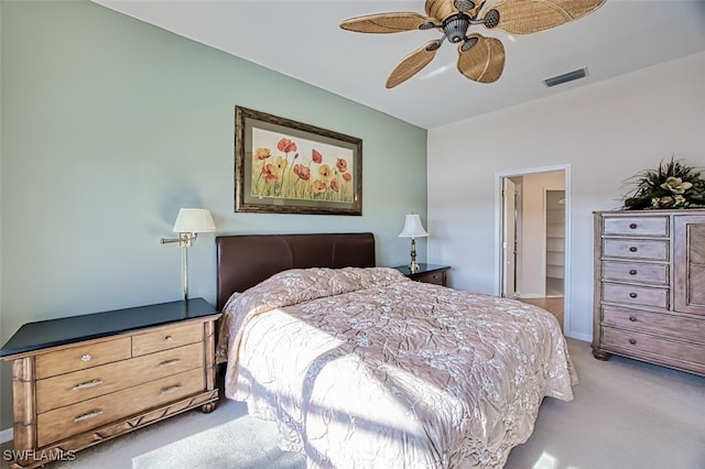 carpeted bedroom with ceiling fan, a spacious closet, and a closet