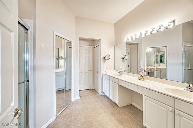 bathroom featuring vanity, tile patterned flooring, and a shower with door