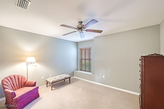 living area featuring ceiling fan and carpet flooring