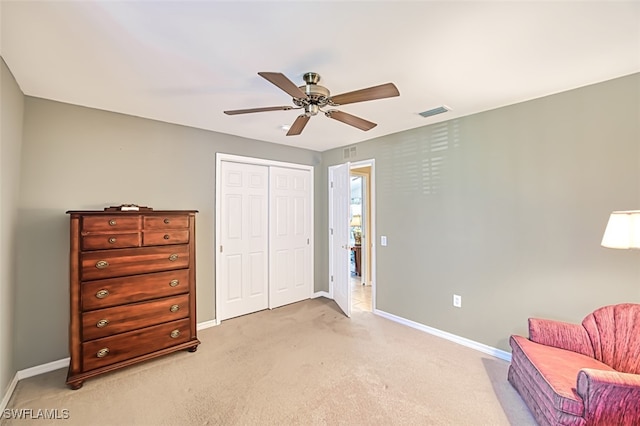 sitting room with ceiling fan and light carpet