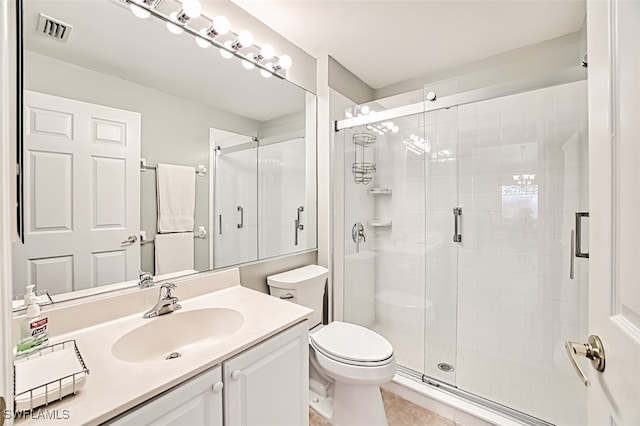 bathroom featuring walk in shower, vanity, and toilet