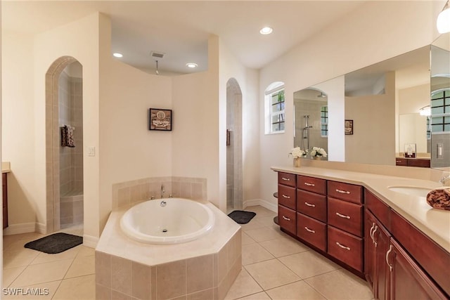 bathroom with tile patterned floors, separate shower and tub, and vanity