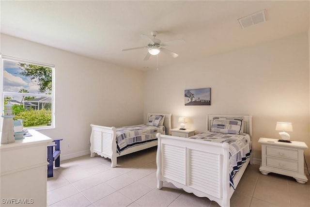 tiled bedroom featuring ceiling fan