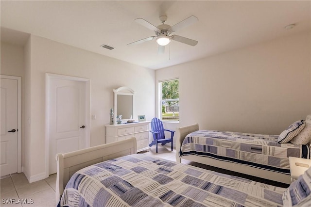 tiled bedroom with ceiling fan