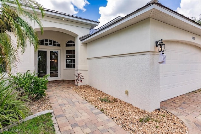 exterior space featuring a garage and french doors