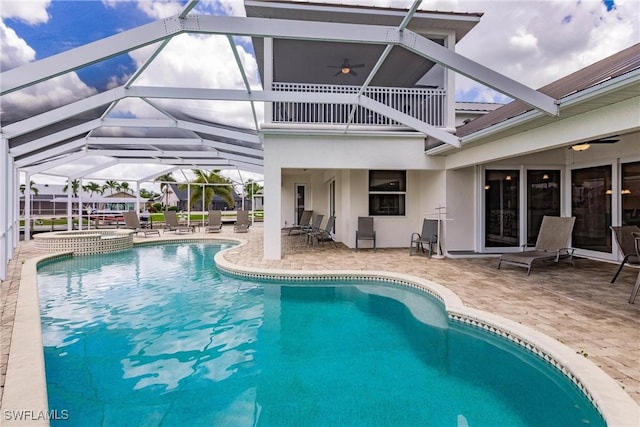 view of swimming pool featuring ceiling fan, a lanai, a patio, and an in ground hot tub