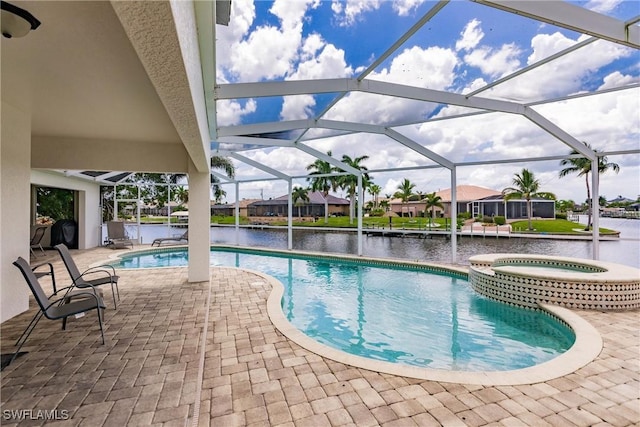 view of pool featuring a lanai, a water view, a patio, and an in ground hot tub