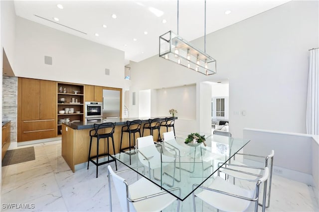 dining area with a towering ceiling