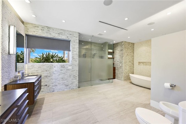 full bathroom featuring toilet, a bidet, tile walls, shower with separate bathtub, and vanity