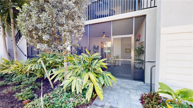 view of exterior entry featuring a balcony