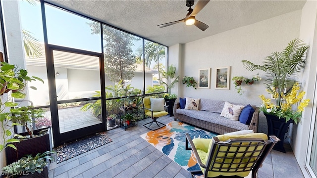 sunroom / solarium featuring ceiling fan