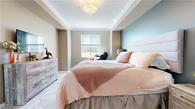 tiled bedroom featuring an inviting chandelier and ornamental molding