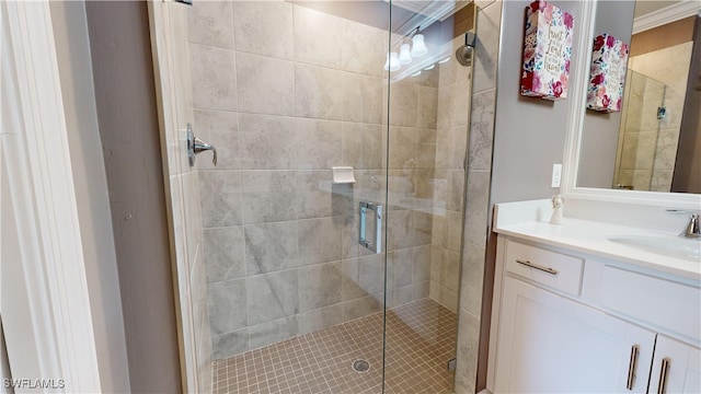 bathroom with a shower with shower door and vanity