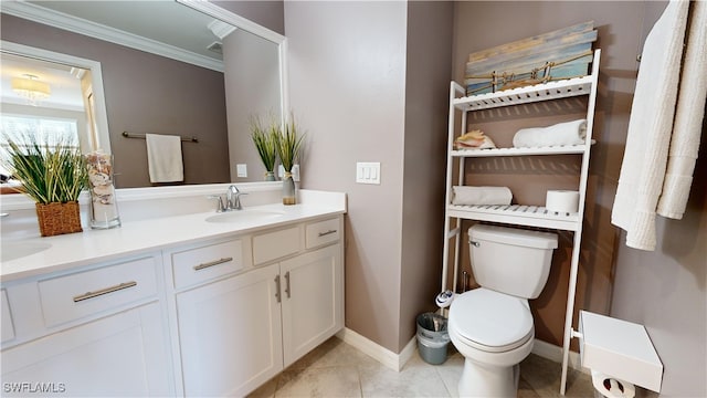 bathroom featuring toilet, vanity, crown molding, and tile patterned flooring