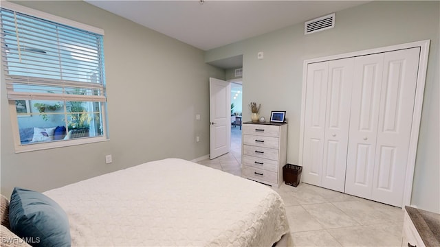 tiled bedroom featuring a closet