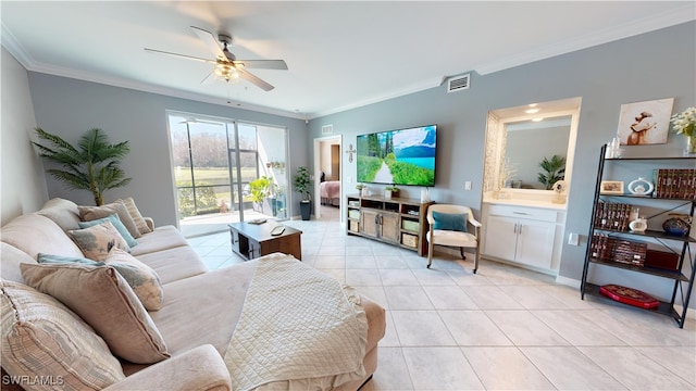 tiled living room with ceiling fan and crown molding